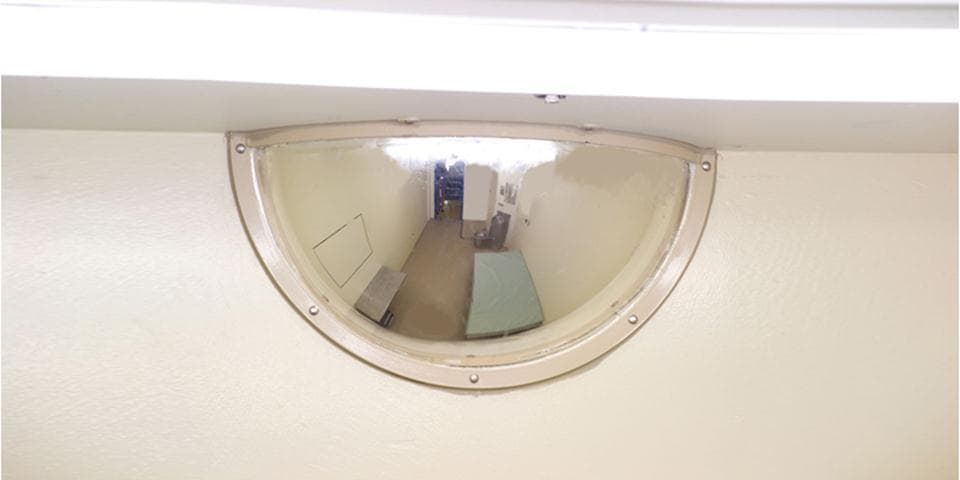 Half dome mirror installed at ceiling level